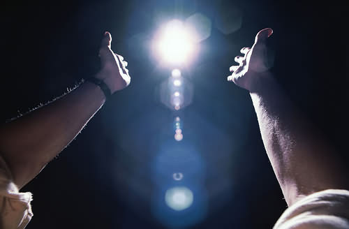 Hands reaching towards light, getty images LS007000 (RF)